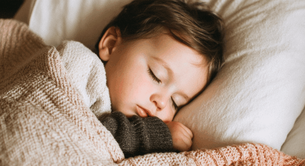 when can babies sleep with a blanket